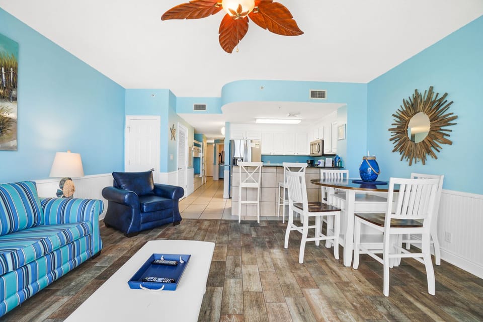 Relax in your bright coastal retreat with ocean-inspired décor, comfy seating, and open-concept living flowing into a fully equipped kitchen.