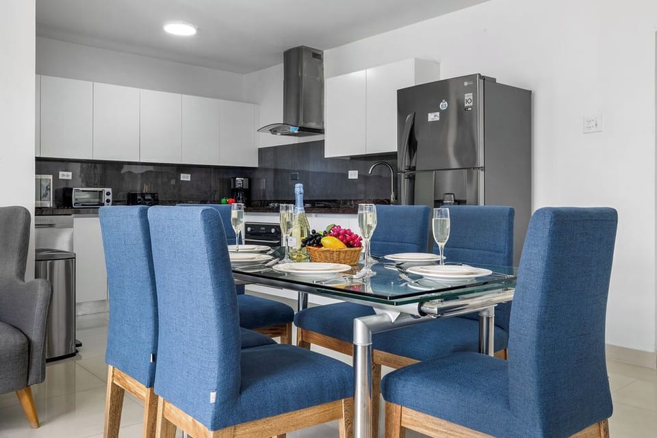 Gather around this cozy dining table in a beautifully designed open-layout space. Whether you're enjoying a homemade meal, a morning coffee, or a special dinner, this inviting setting is perfect for memorable moments with family and friends.