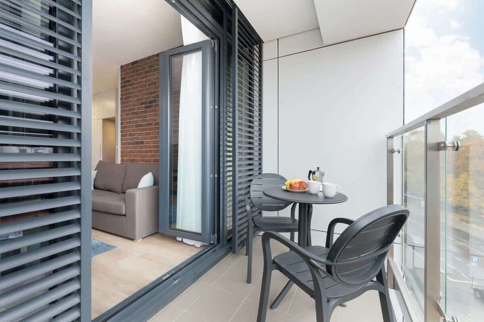 A cozy balcony space with modern furniture for relaxation.