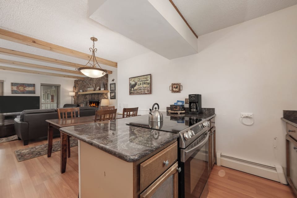 Cook memorable meals in your fully equipped kitchen featuring granite countertops, modern appliances, and an open design that flows into the cozy living space.