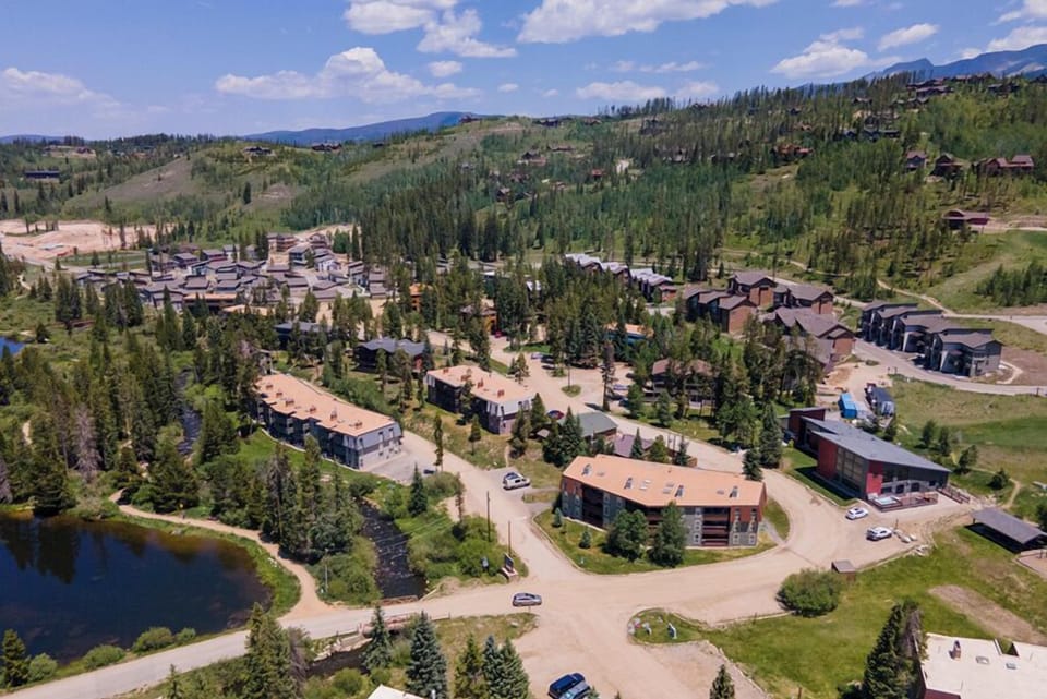 Mountain resort community nestled among evergreen forests with scattered vacation homes throughout the scenic valley landscape.