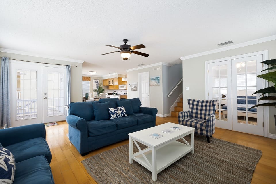 Beautifully furnished living room with large flat screen TV and ample seating for guests. (2nd Floor)