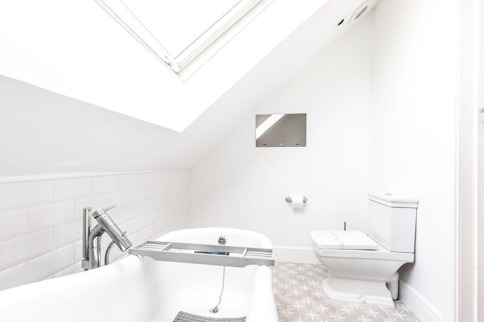 Upstairs bathroom with TV on the wall