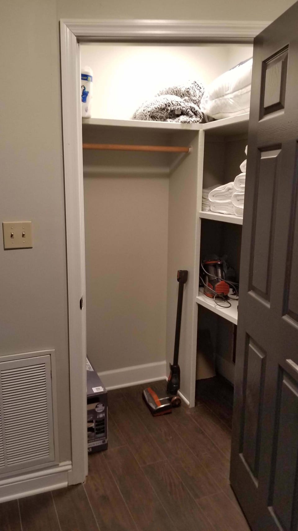 Supply closet with extra towels, air mattress, pillows and cleaning supplies