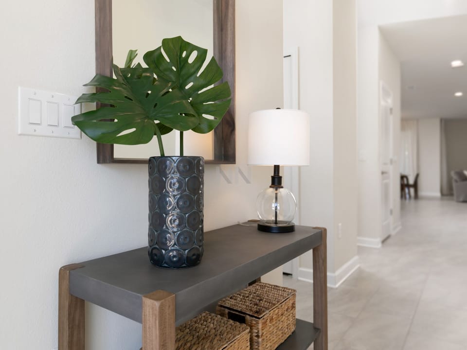Elegant entry hall adorned with a mirror, reflecting style and sophistication.
