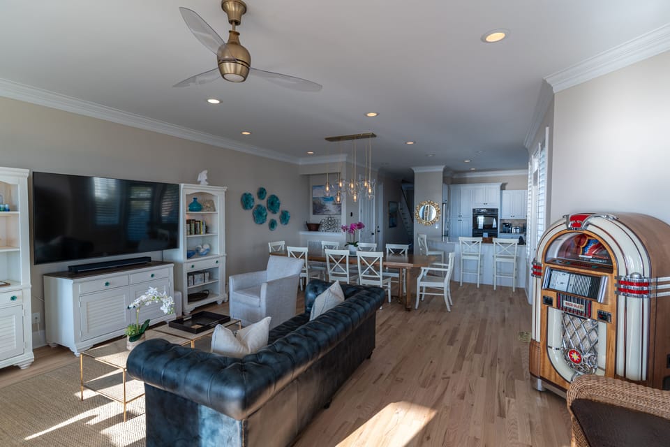 New 75 inch TV in the main living area with comfortable beachy furnishings