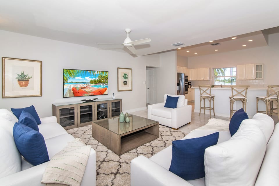 Cozy living area with new sofas and entertainment hub.