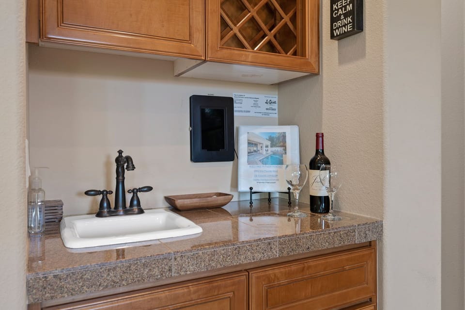 Bar and check in area with pool control tablets and house guidebook 