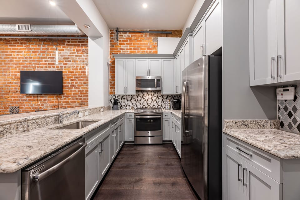 Cook and dine easily in the fully stocked kitchen, equipped with all stainless steel appliances, gas range, basic cookware, and a dining area for a comfortable meal at home. Entertain at the bar with seating for four.