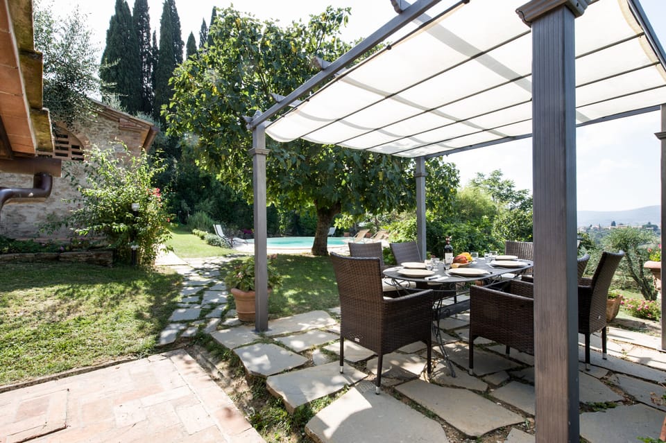 Outdoor dining area with Castrini Cottage  in the background