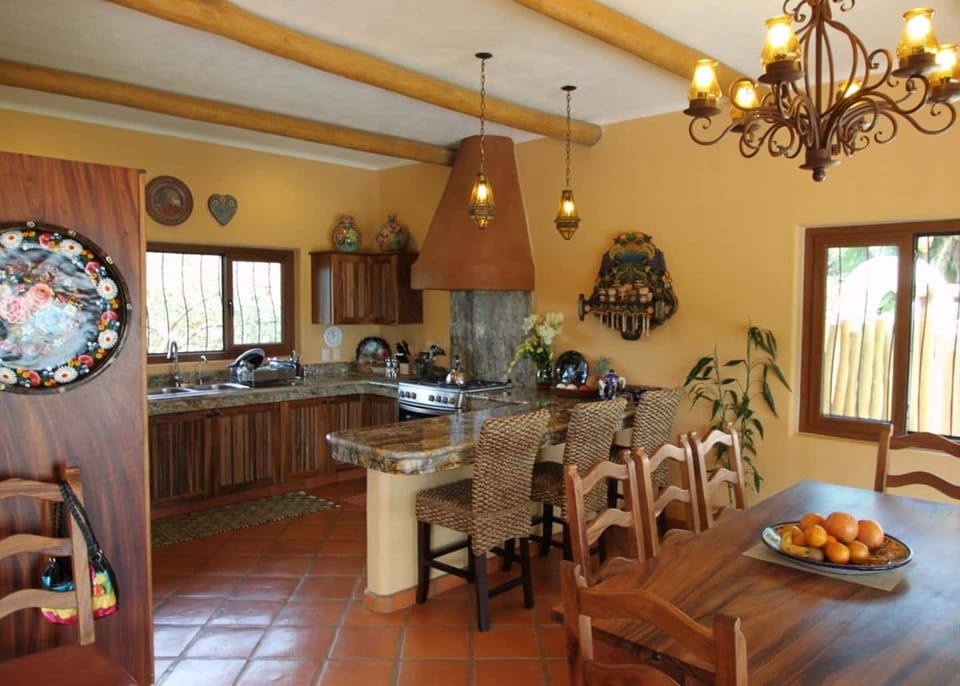 Full kitchen with gas stove and stainless steel appliances.