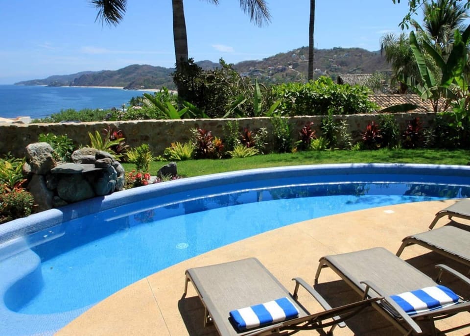 The pool view with the ocean in the distance. Pool is heated with lights.