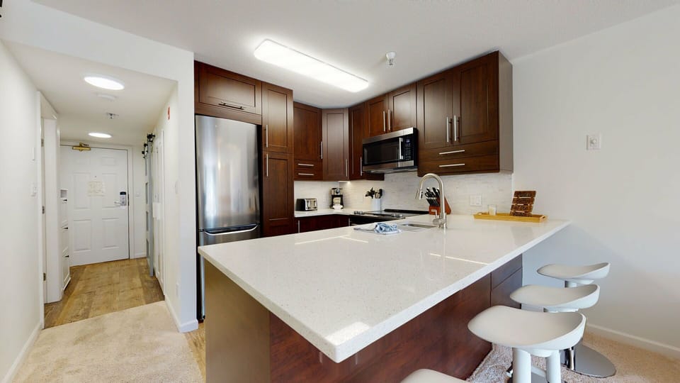 Caesarstone countertops and full-size appliances make cooking a pleasure.