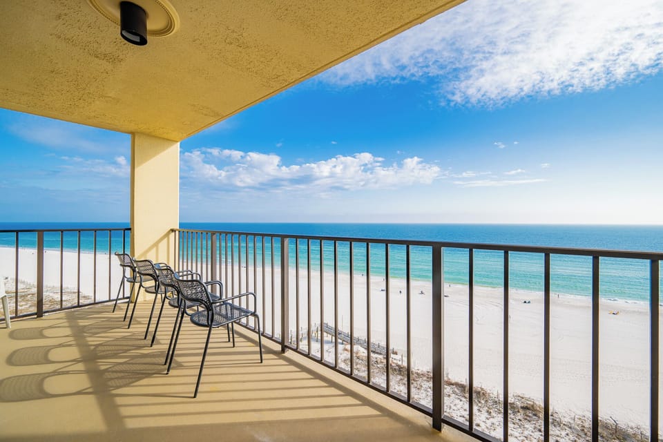 Relax on the balcony enjoying breathtaking views of the serene beach and turquoise waters