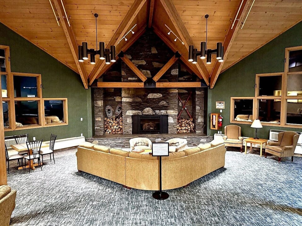 Grand Great Room with Floor-to-Ceiling Stone Fireplace and Cathedral Timber Beams | Open 24 Hours