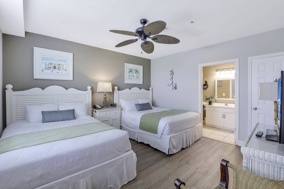 The guest bedroom boasts two queen beds, a flat screen TV and attached full bathroom.