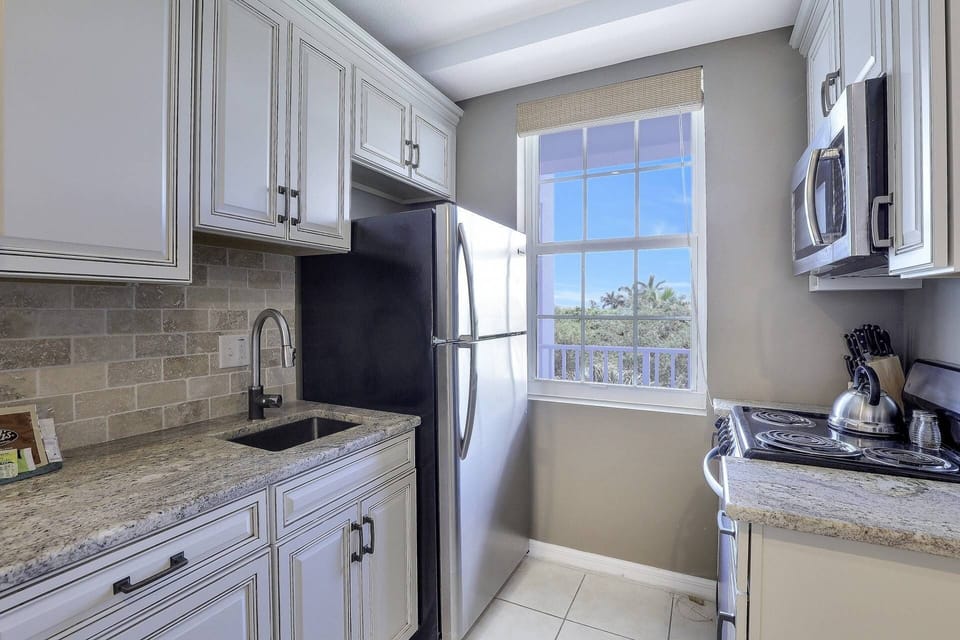 The compact kitchen, while compact, offers plenty of counter space for meal prep.
