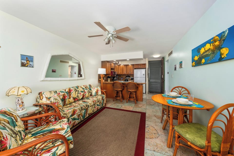 Relax in a bright living area with a comfortable sofa bed, central A/C, and direct access to the lanai with ocean panoramas.