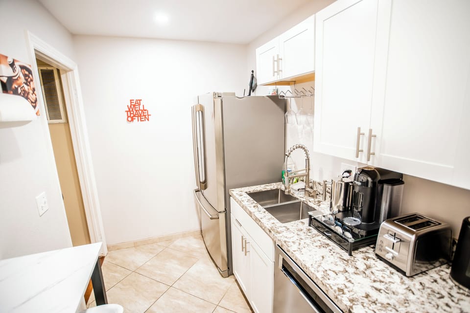 Full kitchenette with stovetop, range hood microwave, full sized fridge/freezer