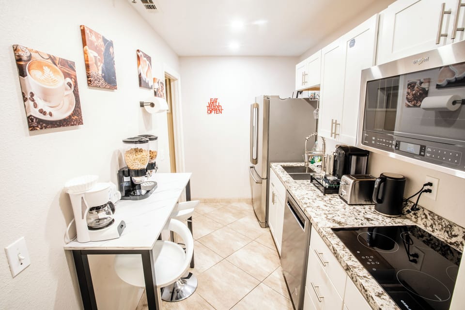 Full kitchenette with stovetop, range hood microwave, full sized fridge/freezer