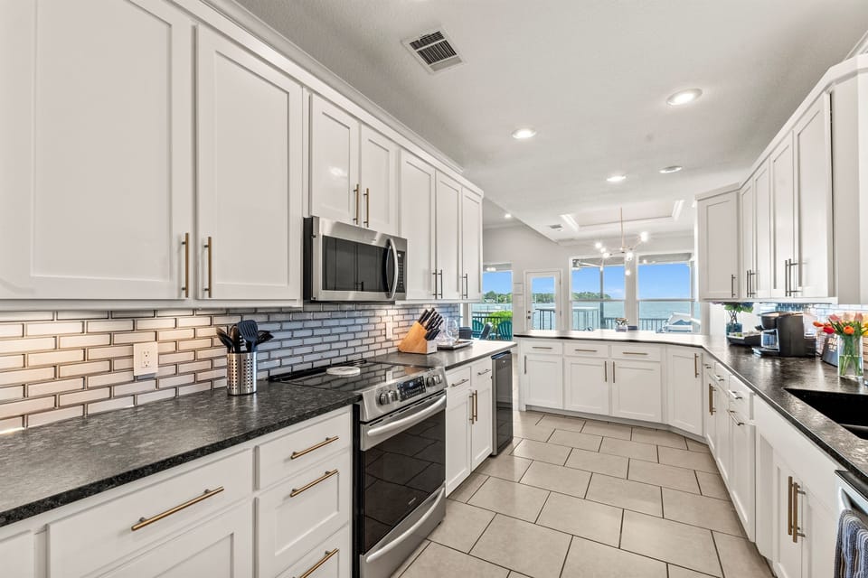 Fully remodeled modern kitchen featuring ample counter space—perfect for preparing meals with ease and style.