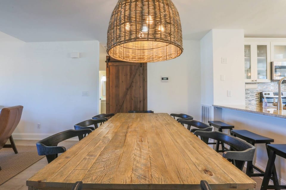 The dining table comfortably seats 8 people.  There are also a total of 5 stools in the kitchen area.