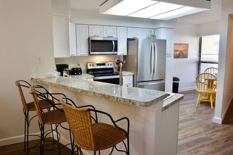 Kitchen with bar stools for additional seating.