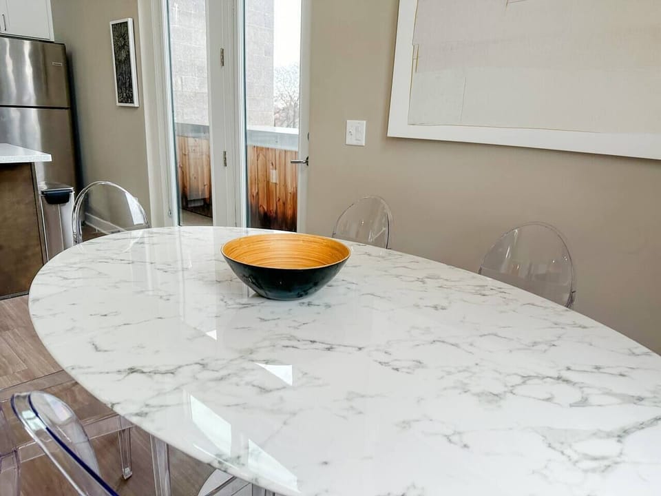 Marble Dining Table for Six with Phillip Starck Ghost Chairs.