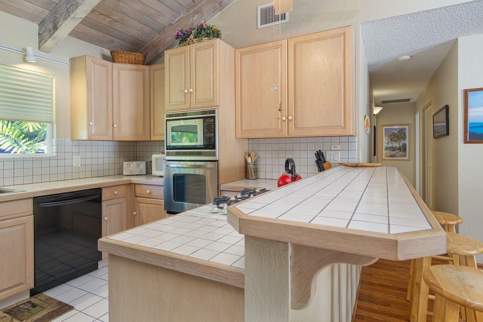 Open kitchen with modern appliances, cookware, and everything needed for gourmet meals or quick snacks.