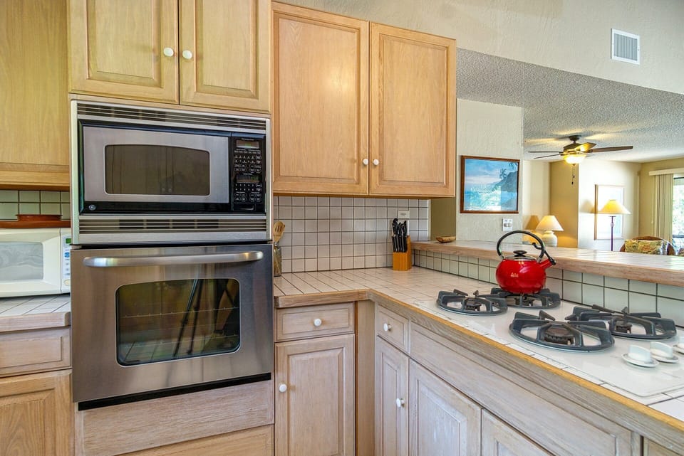 Open kitchen with modern appliances, cookware, and everything needed for gourmet meals or quick snacks.
