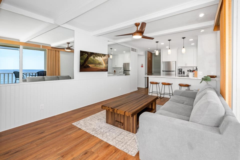Bright, open living area featuring a comfortable sofa bed, perfect for relaxing while enjoying ocean views year-round.