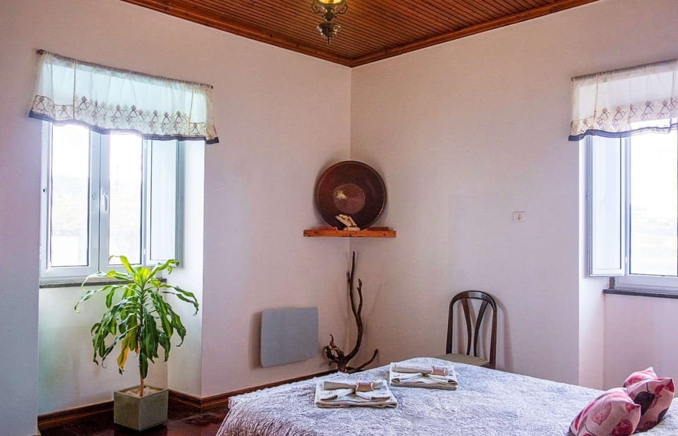 A traditional earthenware bowl adorns the expansive, light-filled master bedroom.