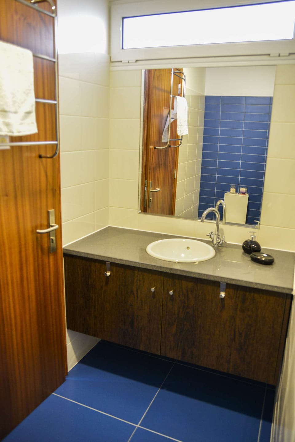 Bathroom features local olivina stone countertop.