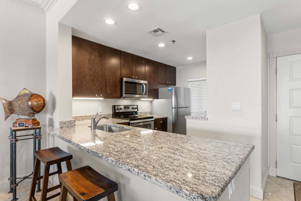 Fully Equipped Kitchen with additional seating at counter.