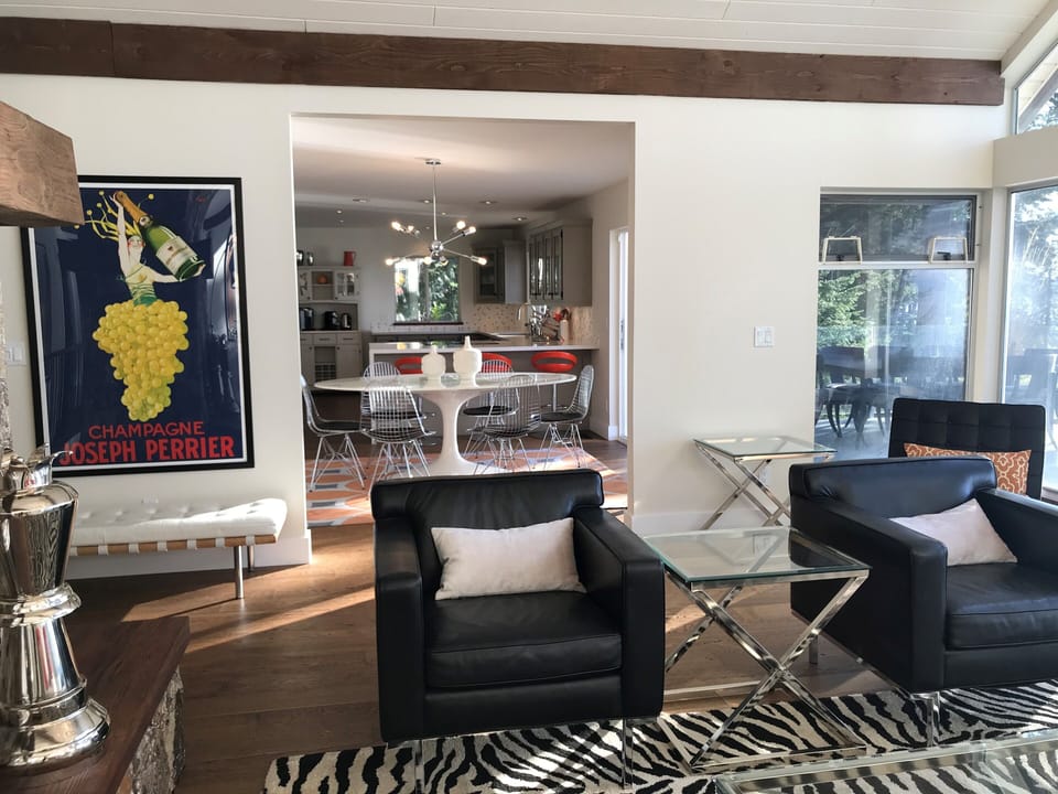 Open-concept living room with mid-century decor - bright & cheerful yet elegant