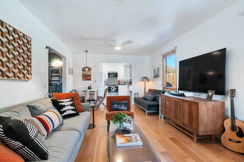 Spacious living room has plenty of space to lounge with smart TV to Netflix and chill or laugh the night away with board games in our TV stand.