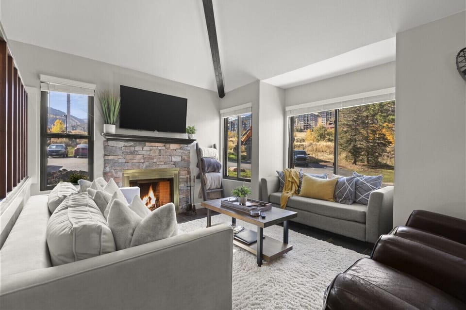 Gather, relax, and reconnect in this open-concept living area with soft seating and the glow of a traditional log fireplace