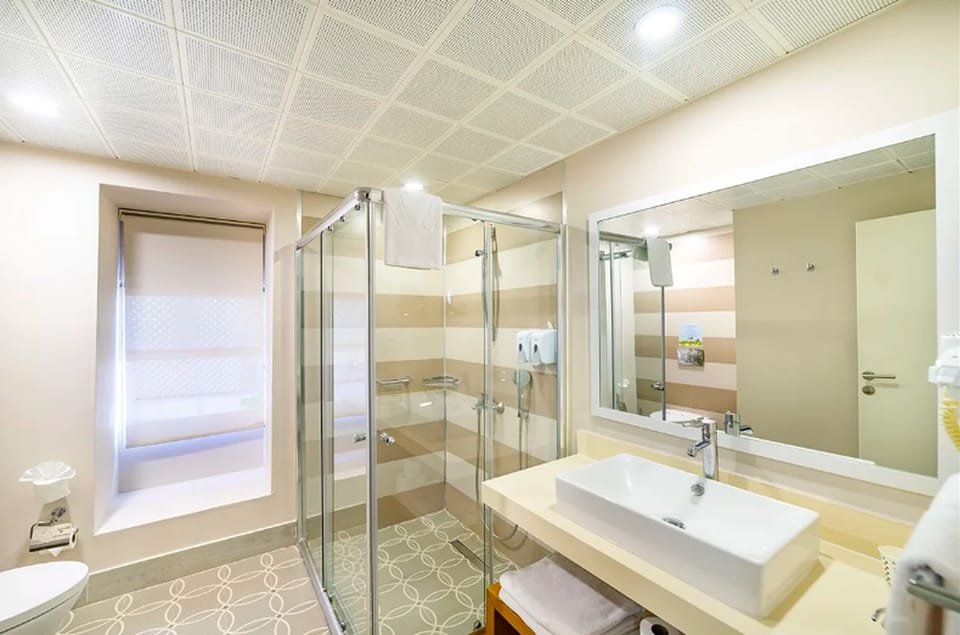 Standard Triple Room, Garden View | Bathroom | Shower, hair dryer, towels, soap
