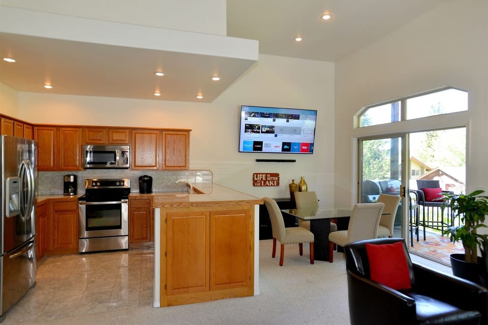 Open design kitchen with counter seating a dining area.