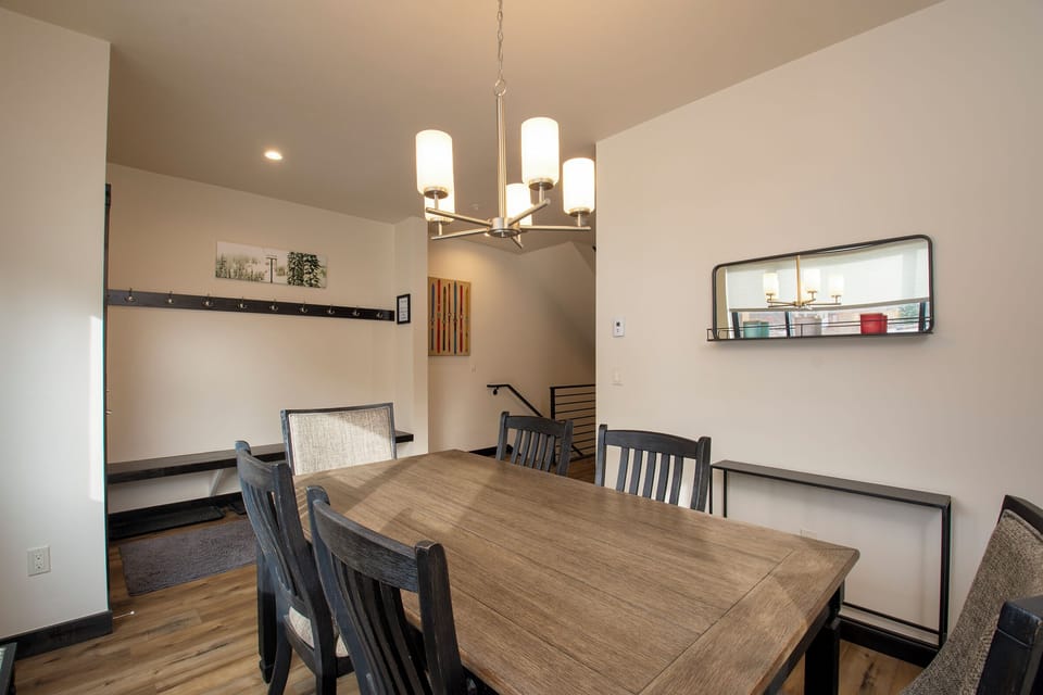 Gather around this elegant dining table where warm lighting and thoughtful design create the perfect setting for memorable meals together.