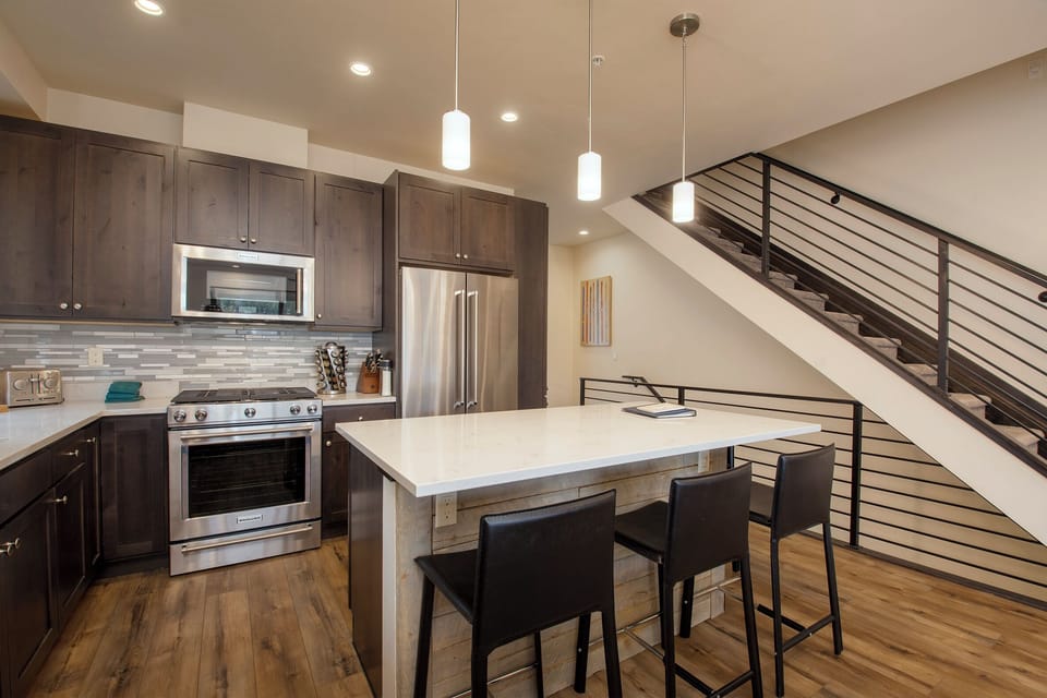 Cook your favorite meals in this modern kitchen with stainless appliances, granite counters, and a breakfast bar perfect for morning coffee.