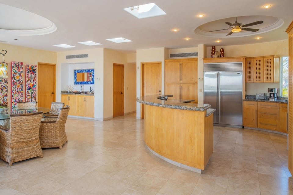 Cook in your spacious open kitchen with granite counters, stainless steel appliances, and tropical breezes from the ceiling fan overhead.