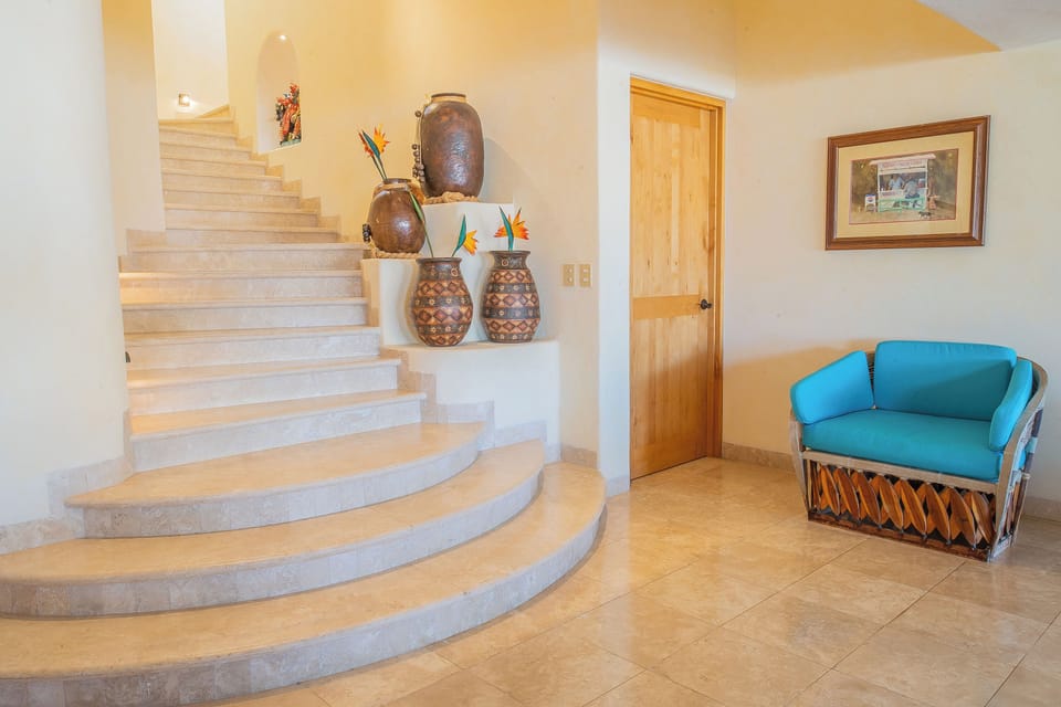 You'll love the warm, artistic touches throughout—handcrafted pottery and vibrant tropical flowers create an inviting atmosphere in your beautiful vacation retreat.