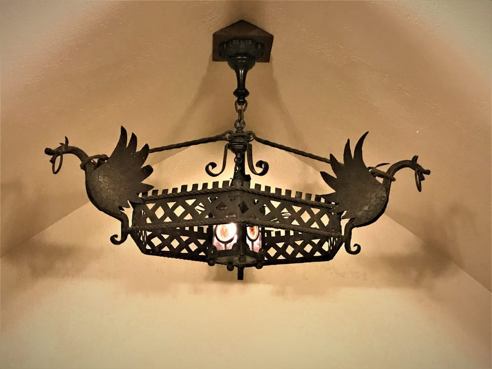 Antique wrought iron dragon night light above the built-in twin daybed