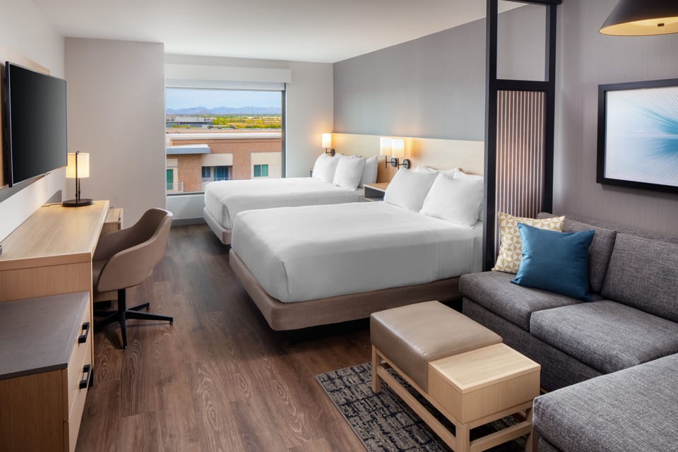 Hypo-allergenic bedding, desk, laptop workspace, blackout drapes