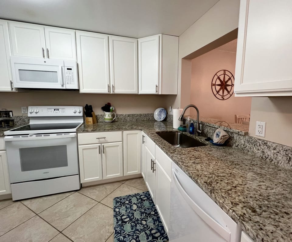 Entrance into the fully equipped kitchen right at the front of t - Entrance into the fully equipped kitchen right at the front of the condo.