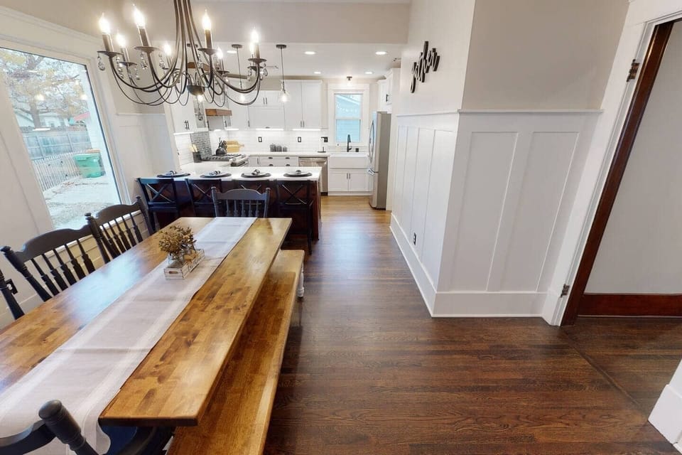 Dining room with large farmhouse table. Beautiful open kitchen.