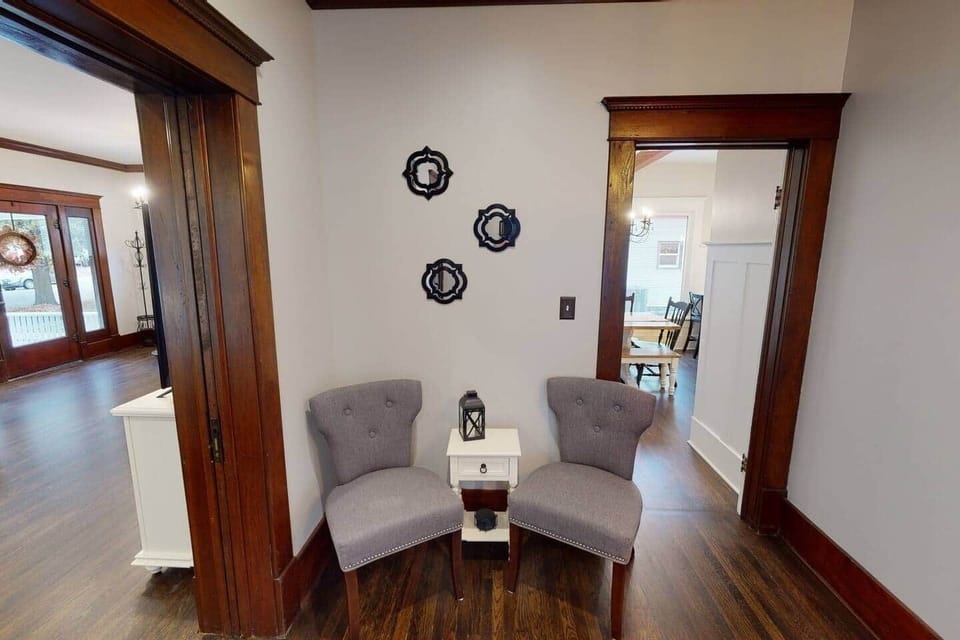 Den with second seating area and view into dining room and living room