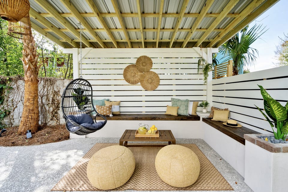 Custom pergola. Ample seating. Chair swing. Palm tree and tropical plants.
