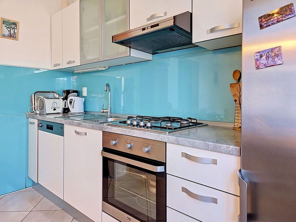Blue, Kitchen, Major Appliance, Countertop, Kitchen Appliance, Interior Design, Kitchen Stove, Flooring, Stove, Apartment